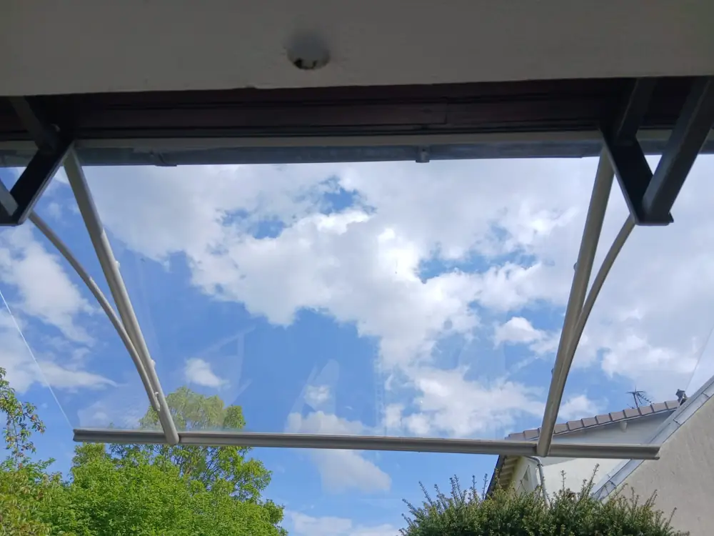 Auvent vitré transparent, nuages visibles au travers